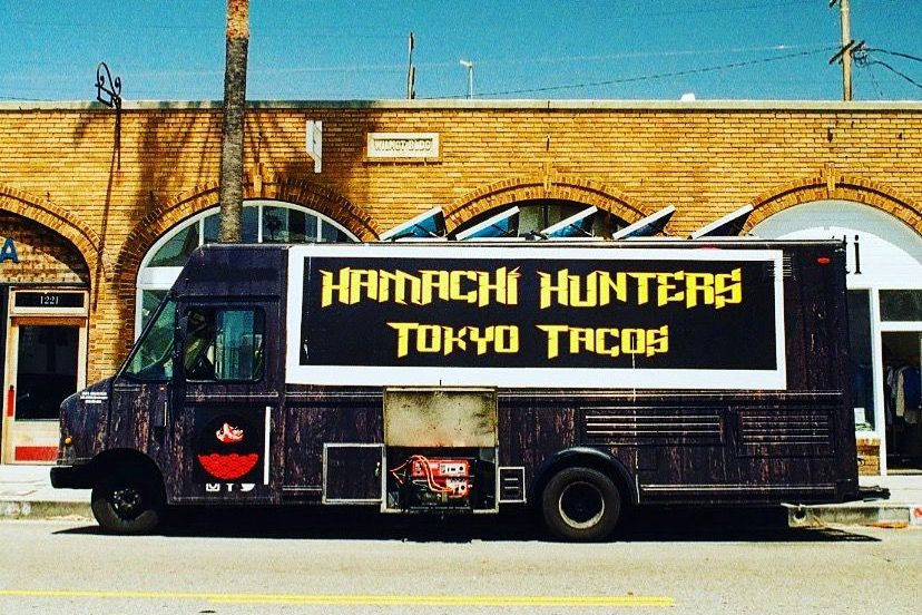 The Hamachi Hunters Tokyo Tacos truck, parked under palms