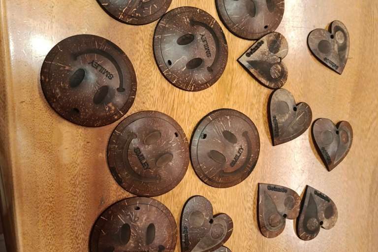Hand-cut coconut-shell buttons and toggles on a workbench