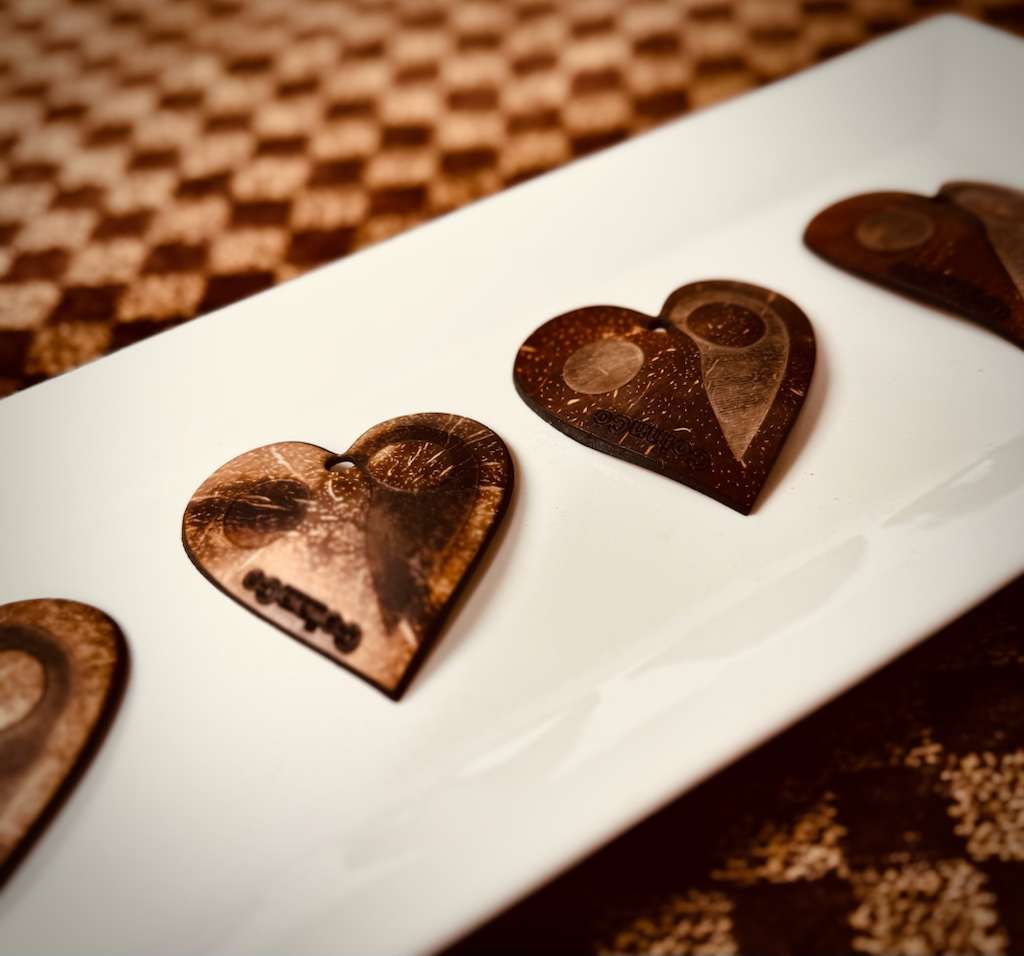 Heart cut from real coconut shell, two tones meeting like a yin-yang
